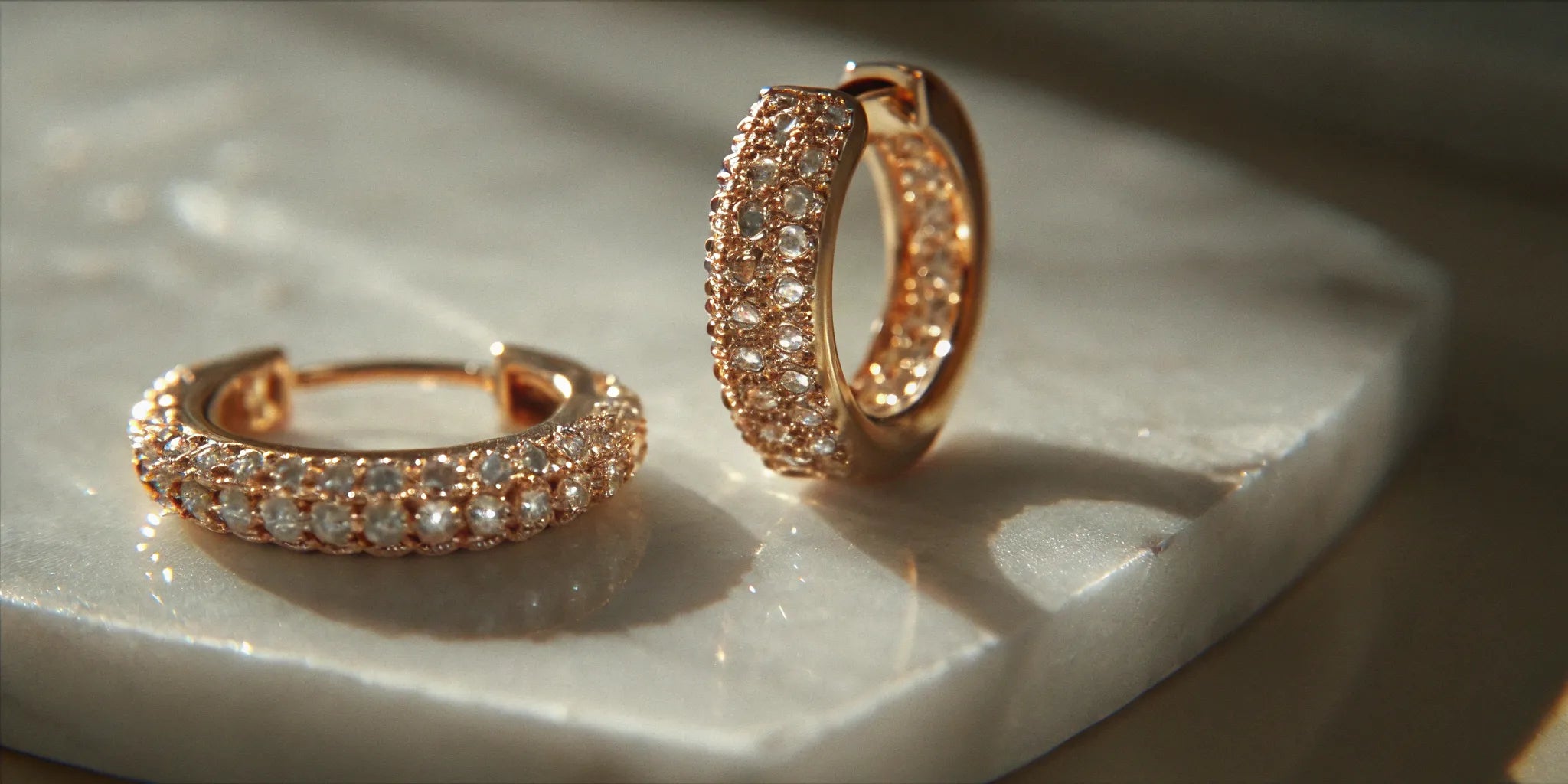 14k gold huggie earrings with pavé diamonds.