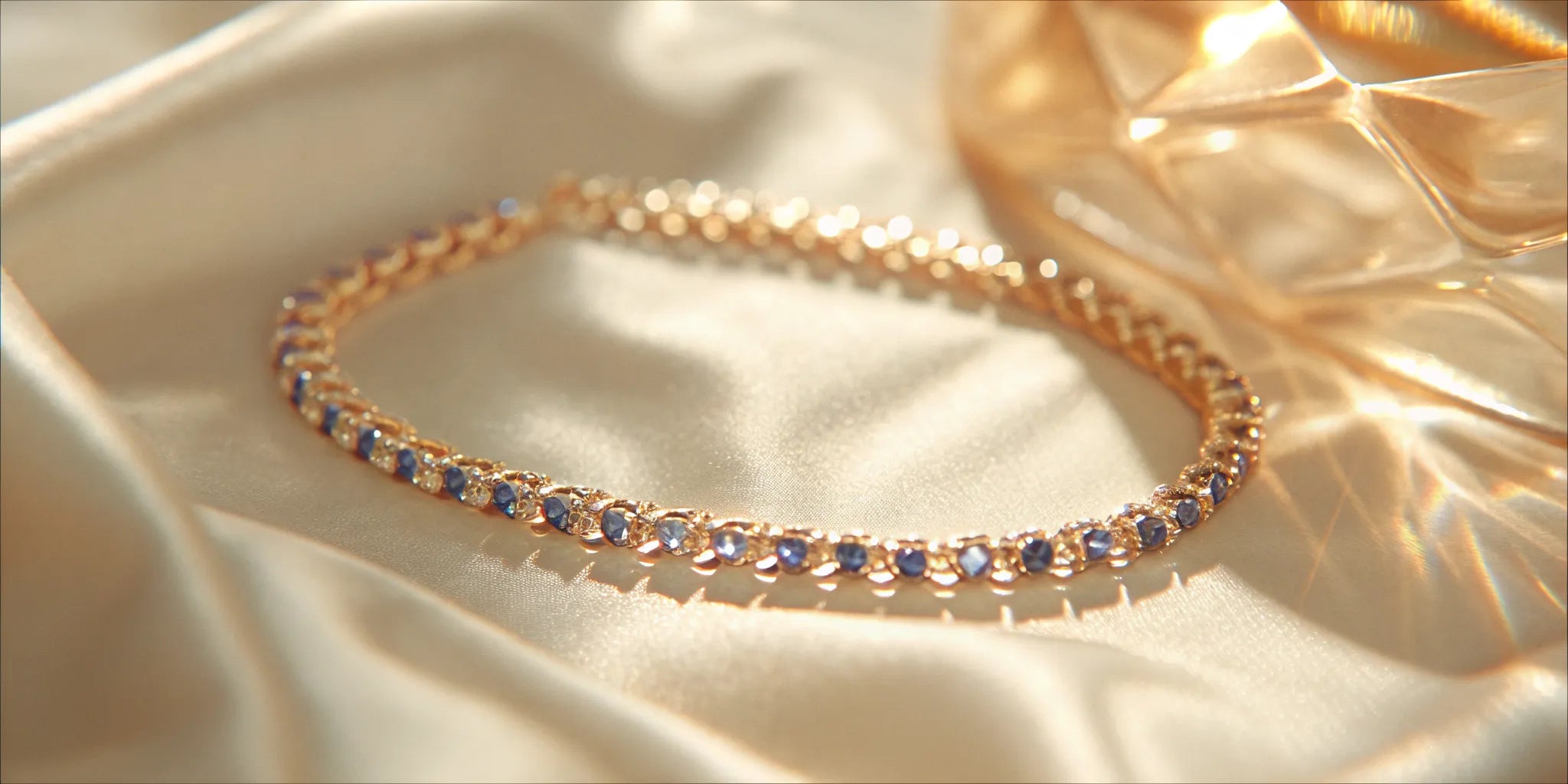 A blue sapphire tennis bracelet with round-cut stones in a yellow gold setting.