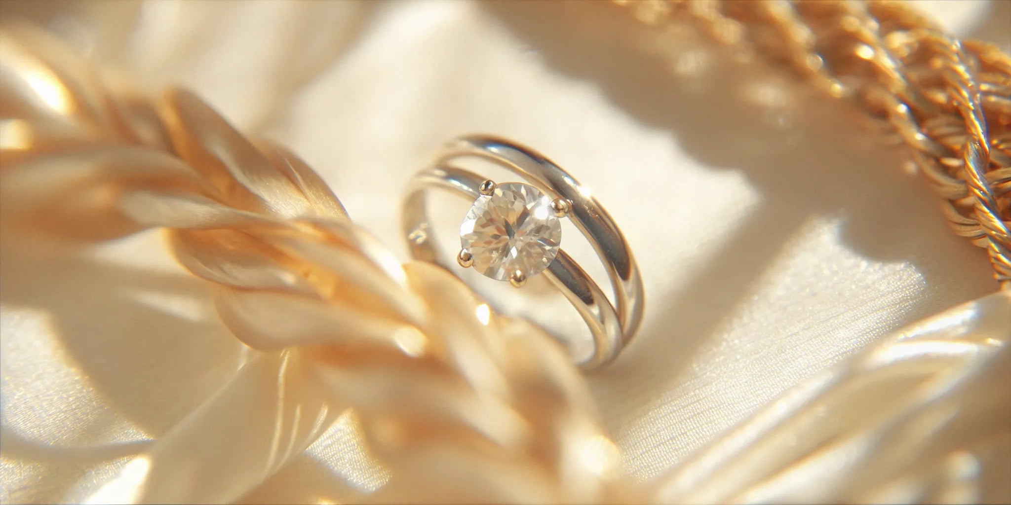 A classic solitaire diamond pinky ring styled with other gold jewelry.