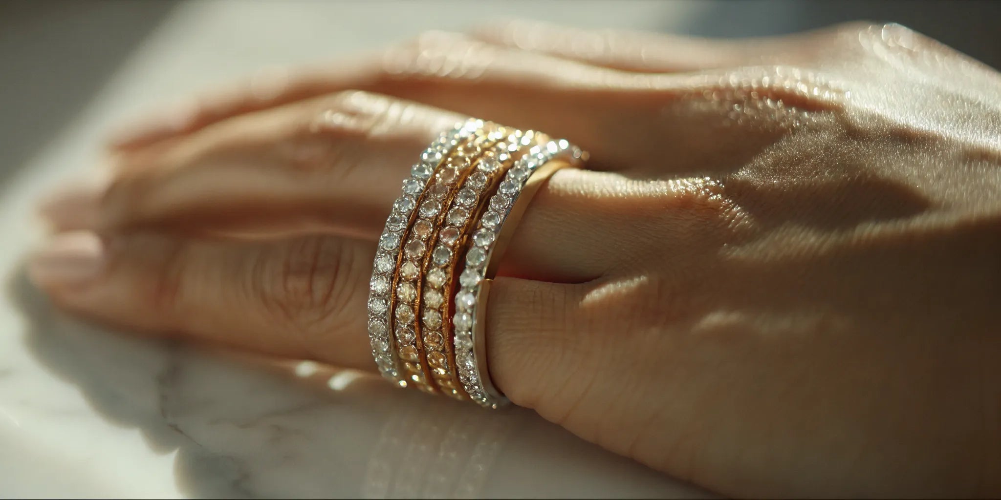A hand wearing a collection of stackable diamond rings in West Palm Beach.