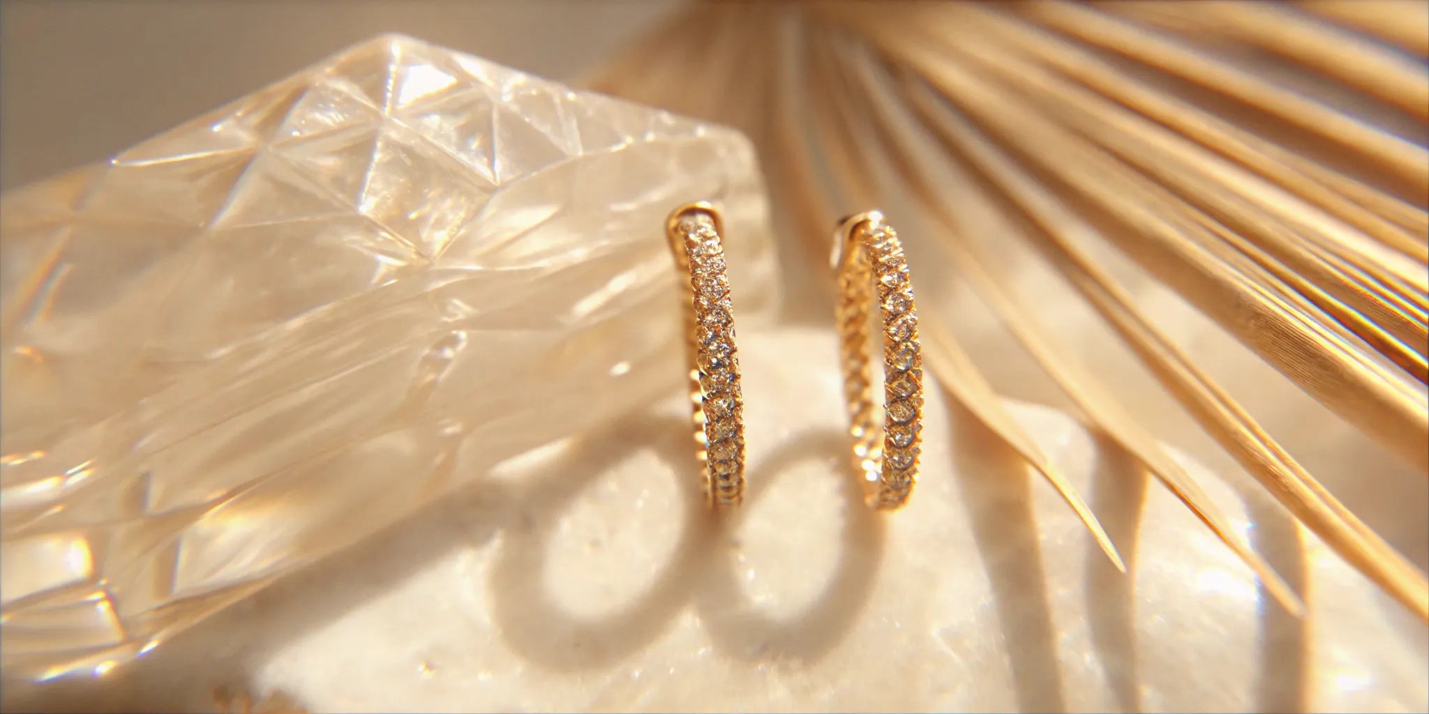 Pave diamond huggies in gold, a popular style in West Palm Beach.