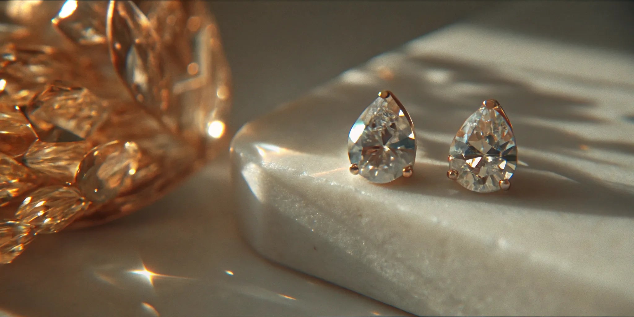 Custom pear diamond stud earrings in a gold prong setting.
