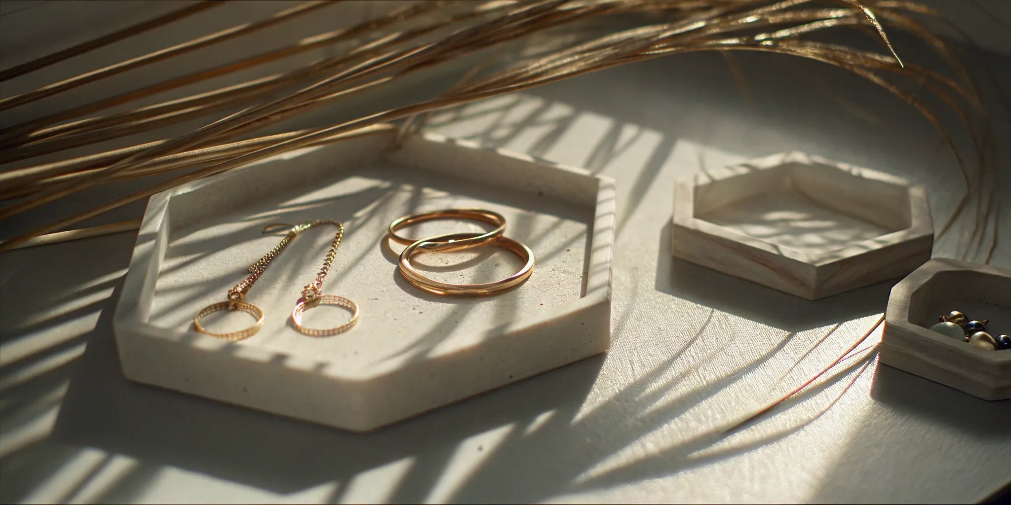 Sustainable gold rings and earrings with palm shadows in Palm Beach Gardens.