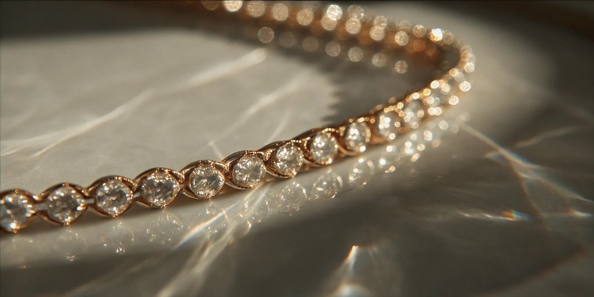 A quality 18k gold tennis bracelet with diamonds in a durable bezel setting.