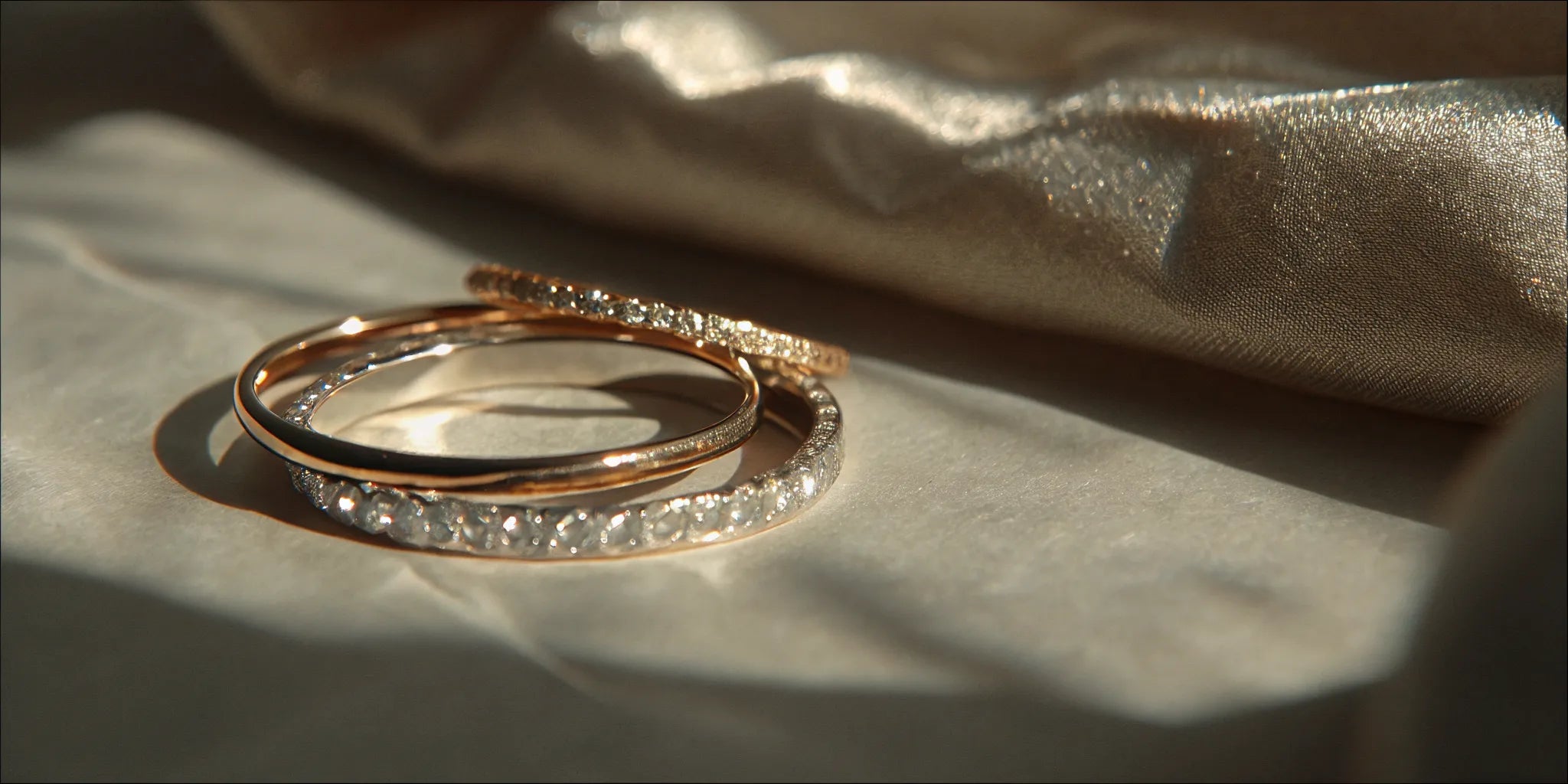 A stack of gold and diamond pinky rings in different styles.
