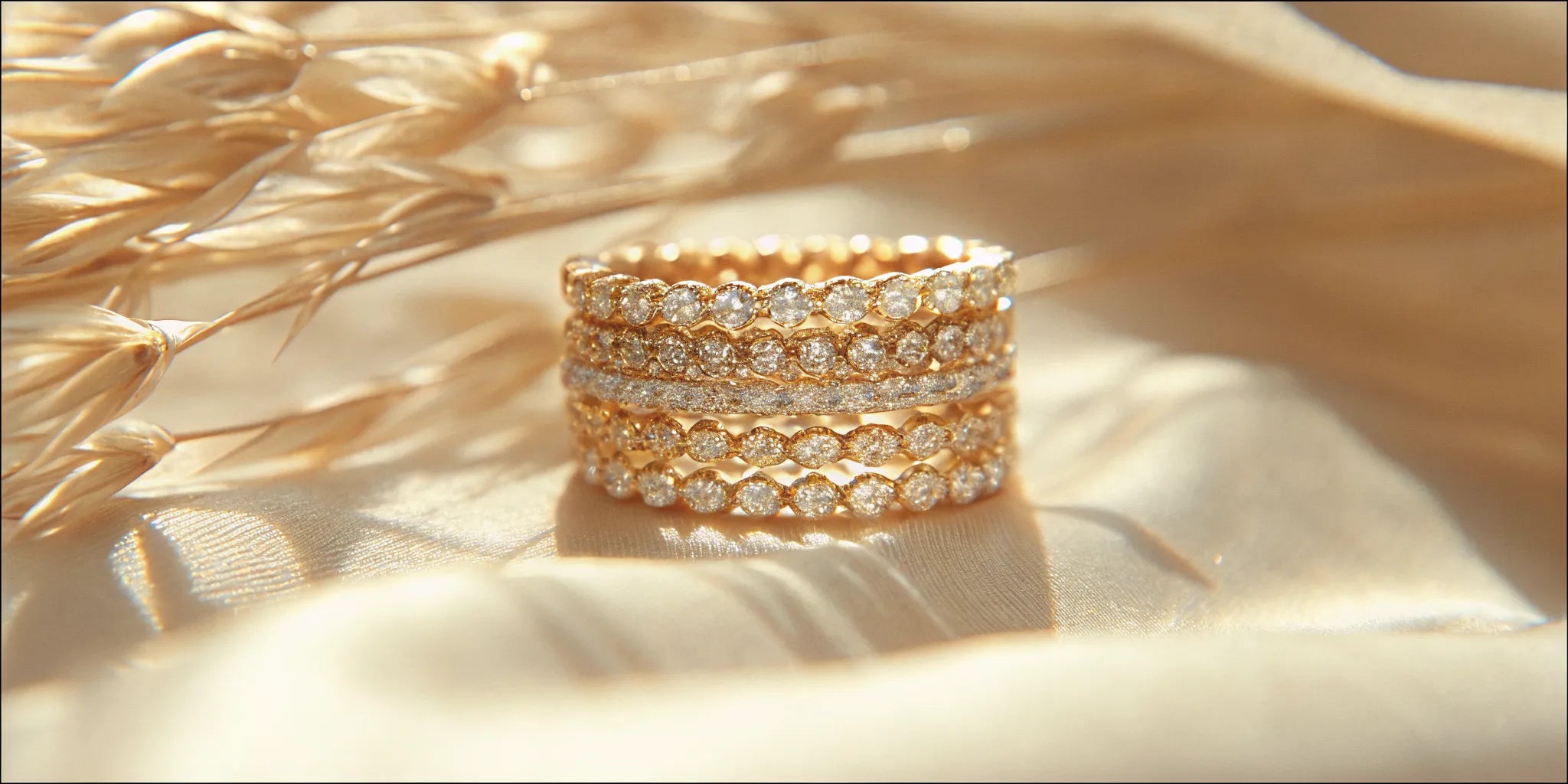 An elegant collection of solid yellow and white gold rings stacked beautifully on a hand