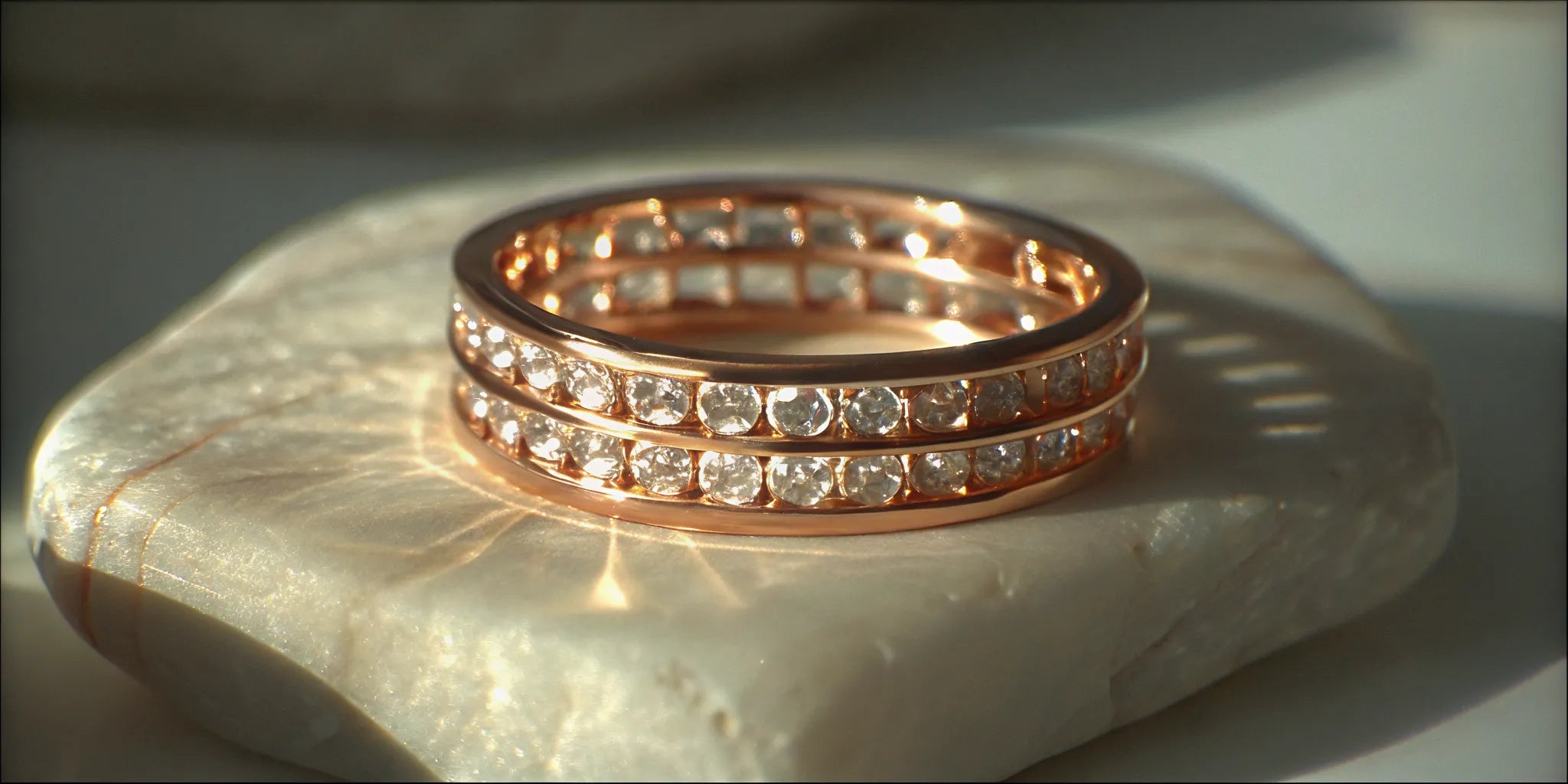 Modern rose gold floating diamond band with two rows of round diamonds.