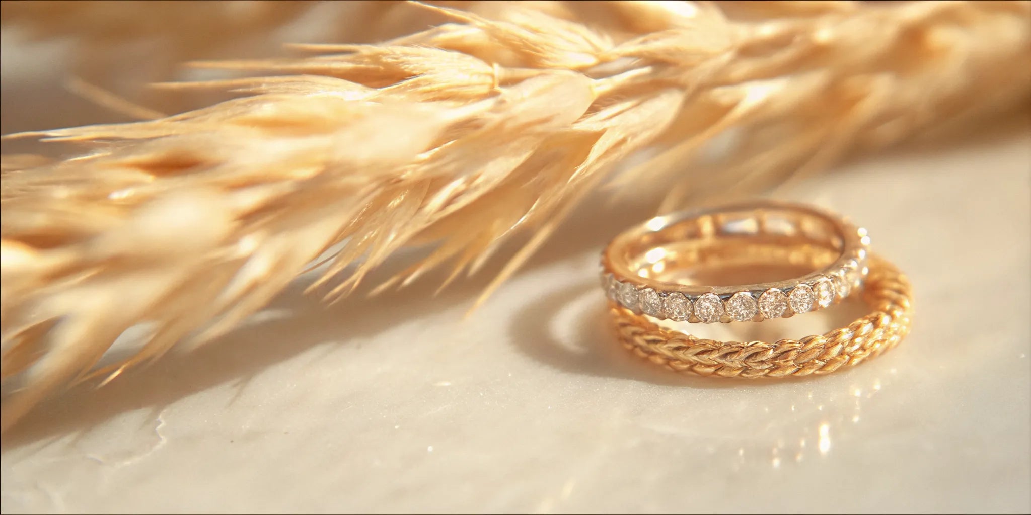 Mismatched stacked wedding bands in gold with diamonds.